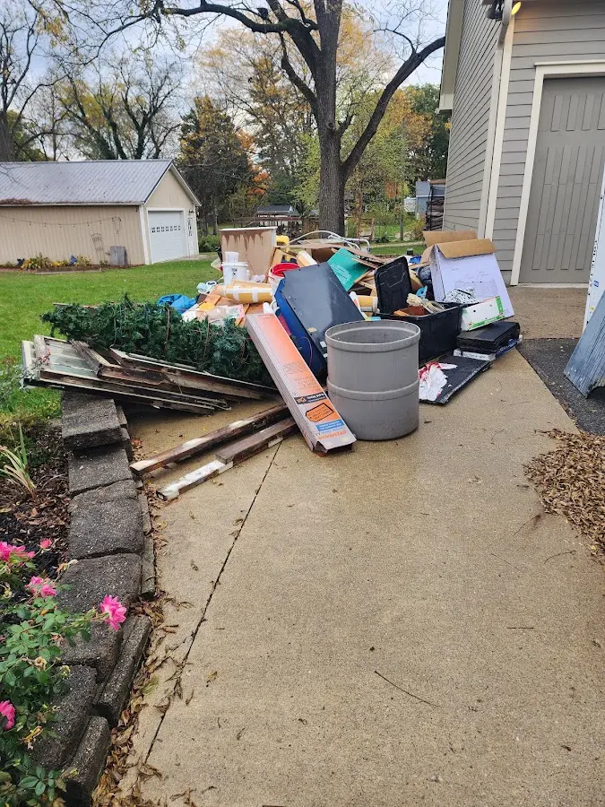 Dumpster being loaded with debris for Estate Cleanout Dumpster Rental in Mount Healthy Heights